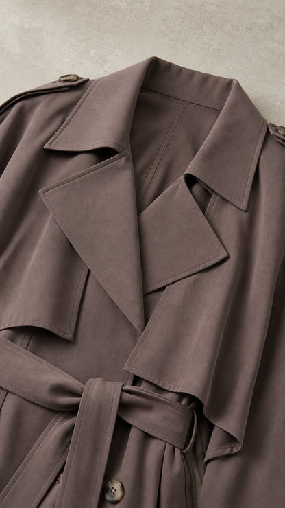 Close up of dark taupe trench coat lapel and belt