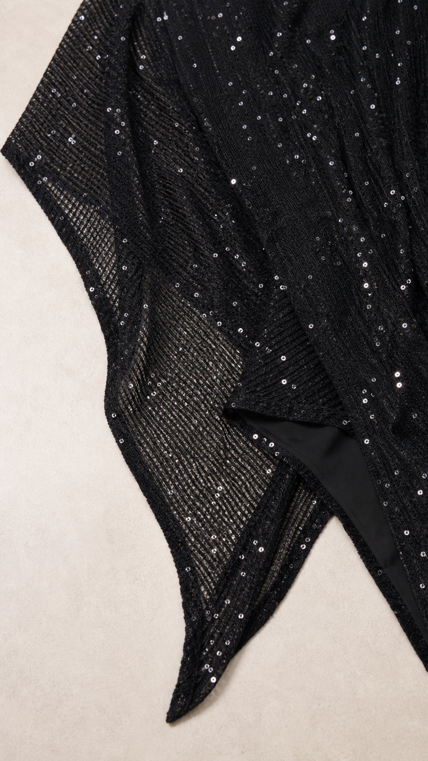 Close-up detail of sheer mesh fabric with shimmering sequin embellishment