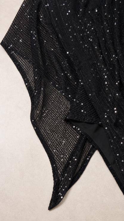 Close-up detail of sheer mesh fabric with shimmering sequin embellishment