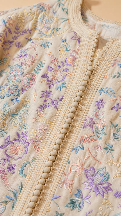 Close-up of embroidery and button details on kaftan
