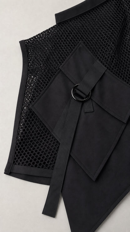Close-up of black mesh vest showing pocket and D-ring detail