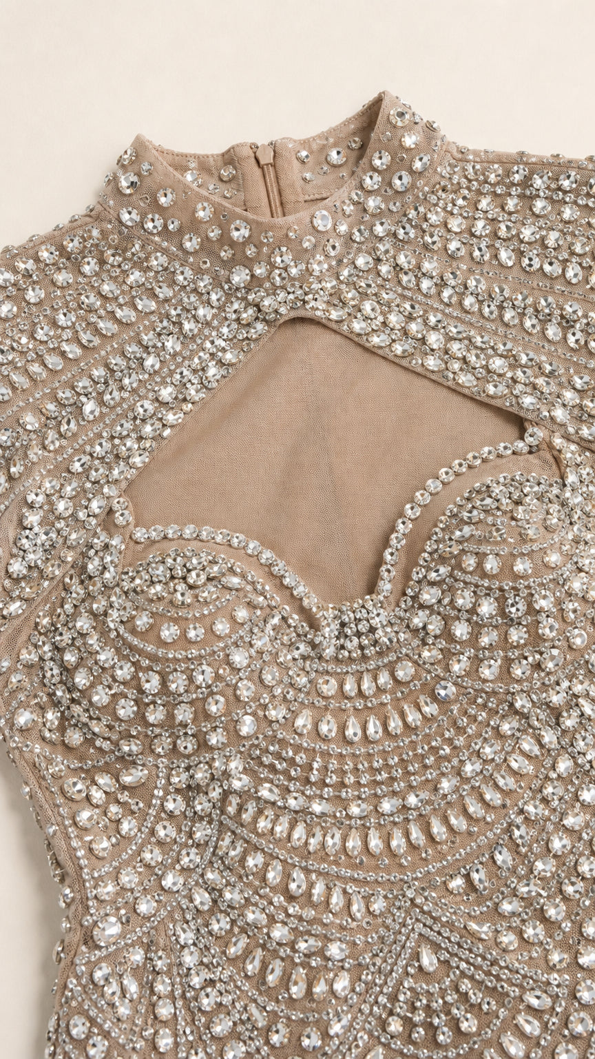Close-up detail of rhinestone beadwork and mock neck