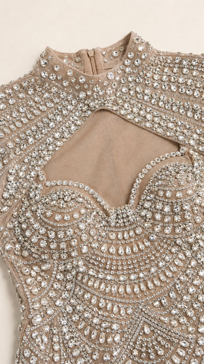 Close-up detail of rhinestone beadwork and mock neck
