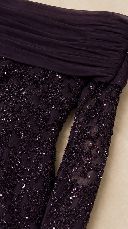 Close-up detail of dark plum draped neckline and sequin sleeve