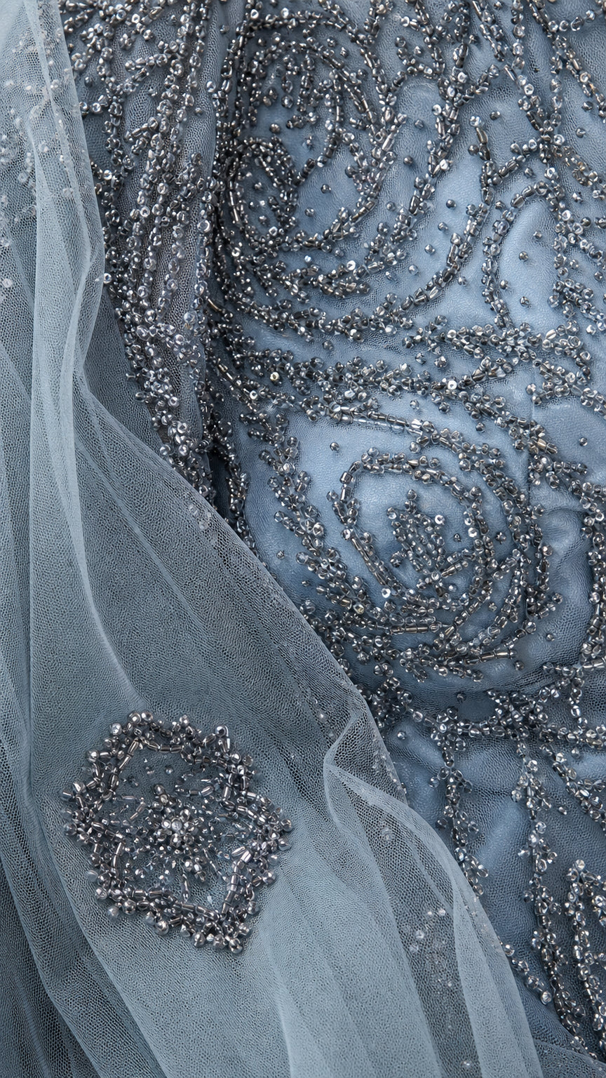 Close up detail of intricate beadwork sequins and embroidered sheer fabric