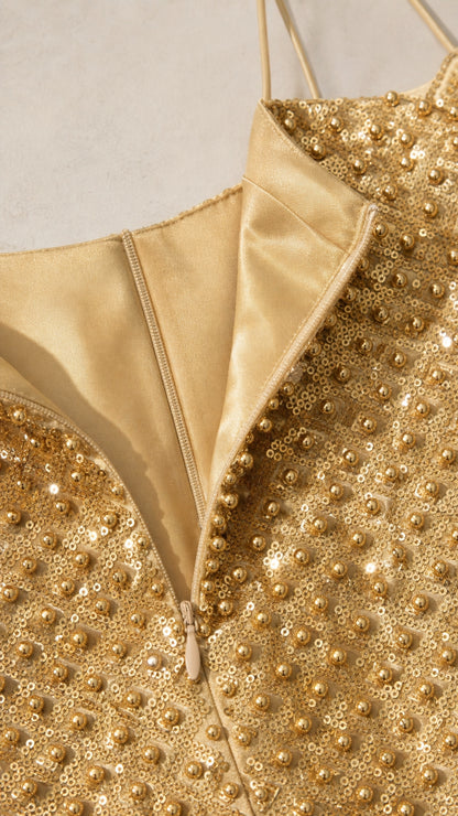 Close-up of gold sequin dress zipper and texture details