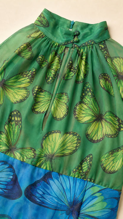Close-up detail of gathered halter neck and keyhole cut on butterfly fabric