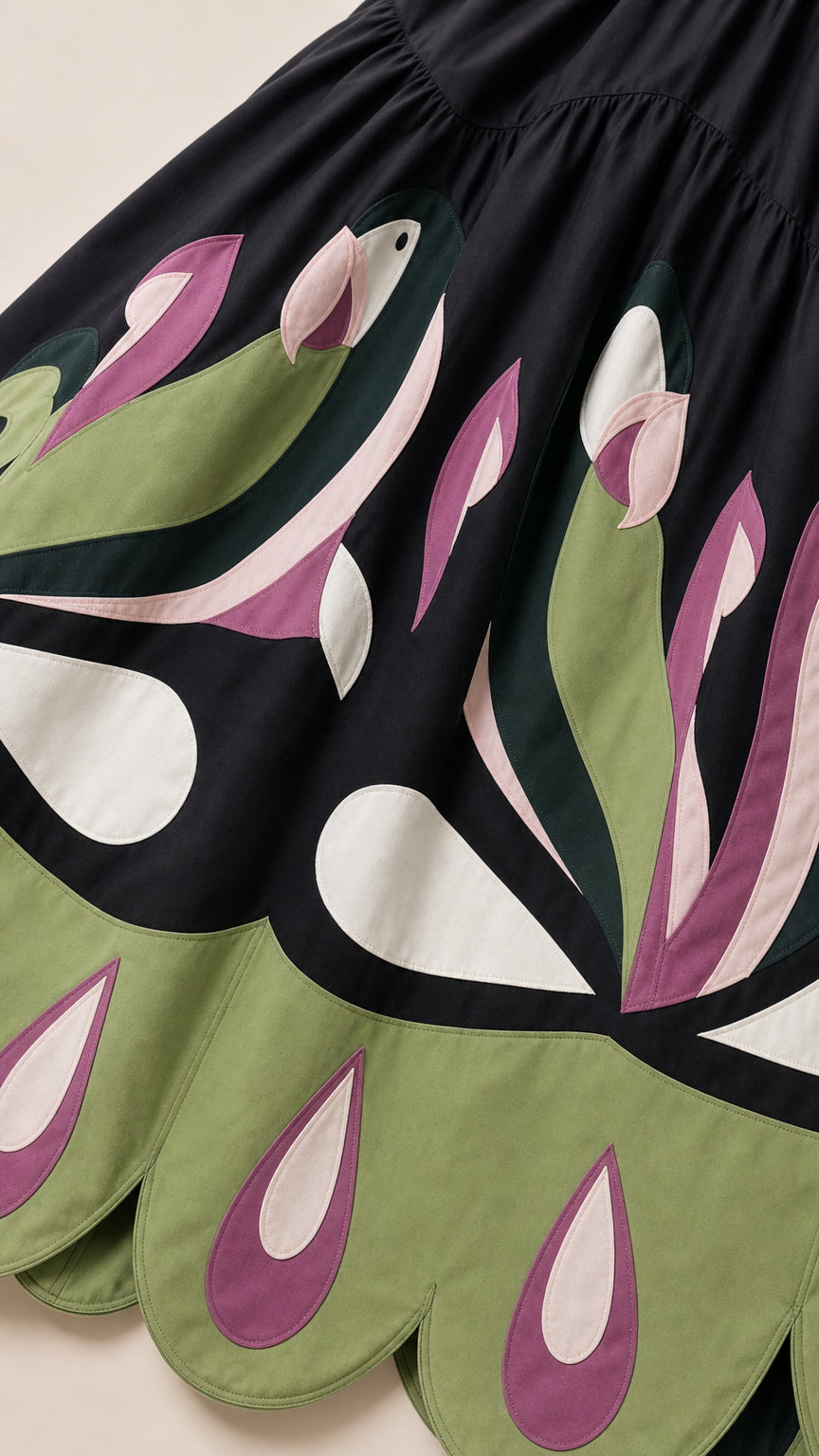 Close-up detail of the contrast floral motif and scalloped hem