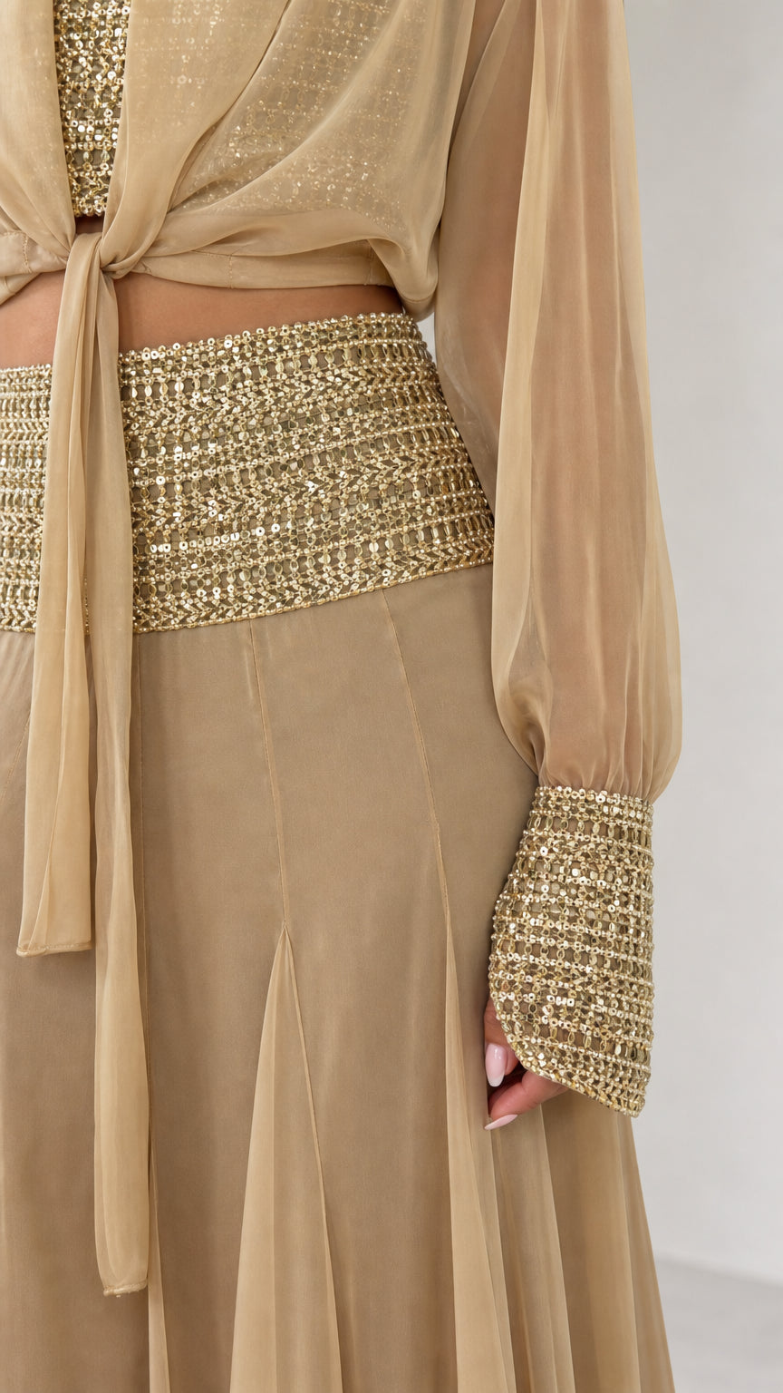 Close-up of sequin waistband and embellished cuff on champagne set