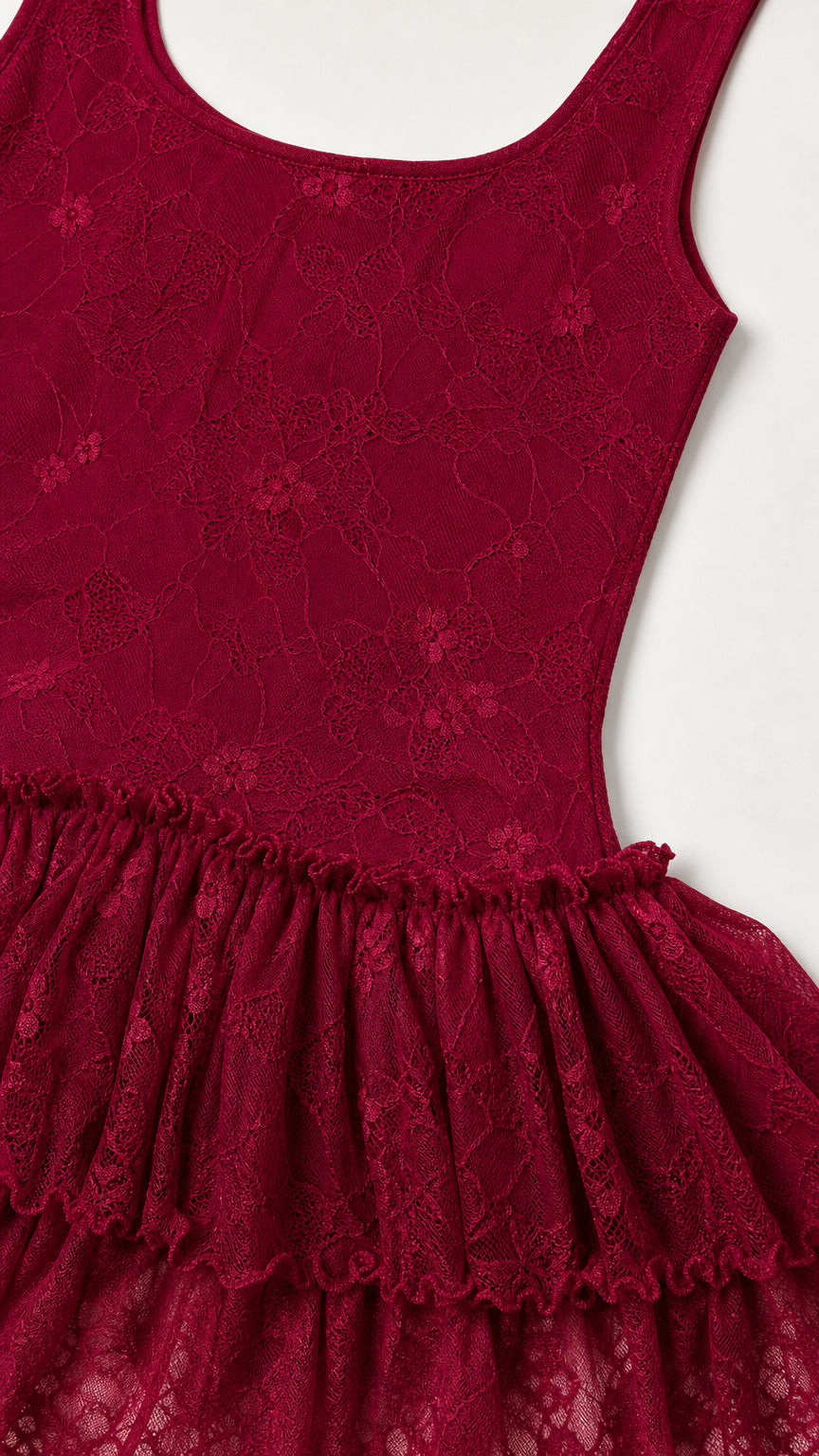 Close-up detail of lace fabric and tiered ruffles on burgundy dress