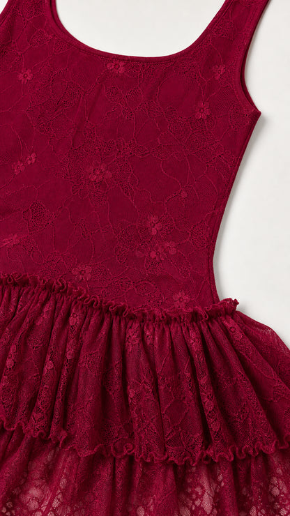 Close-up detail of lace fabric and tiered ruffles on burgundy dress