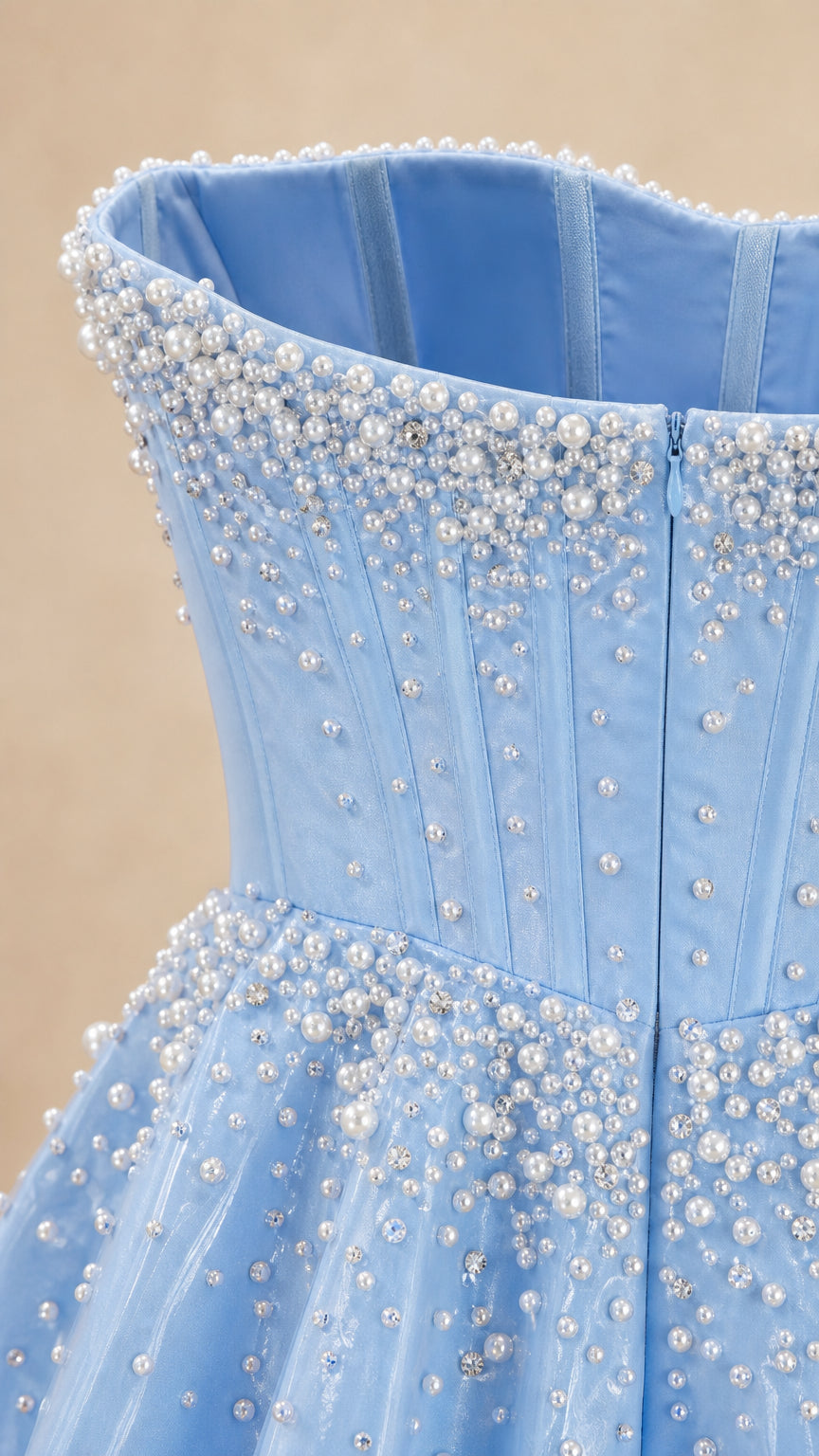 Close-up detail of pearl and bead embellishments on bodice