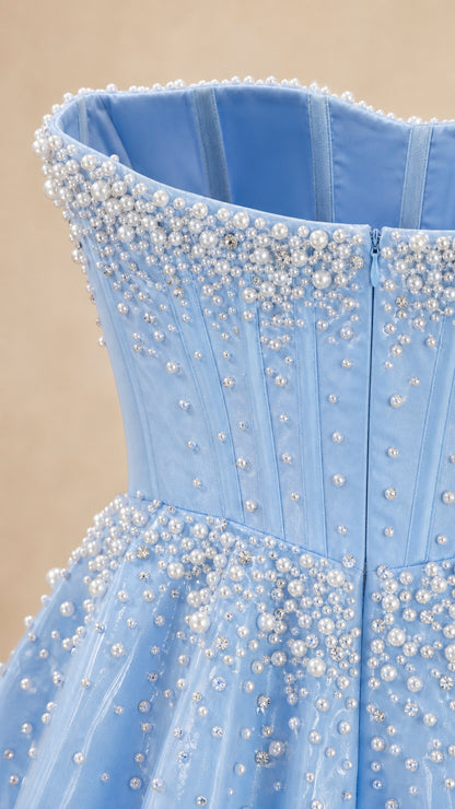 Close-up detail of pearl and bead embellishments on bodice