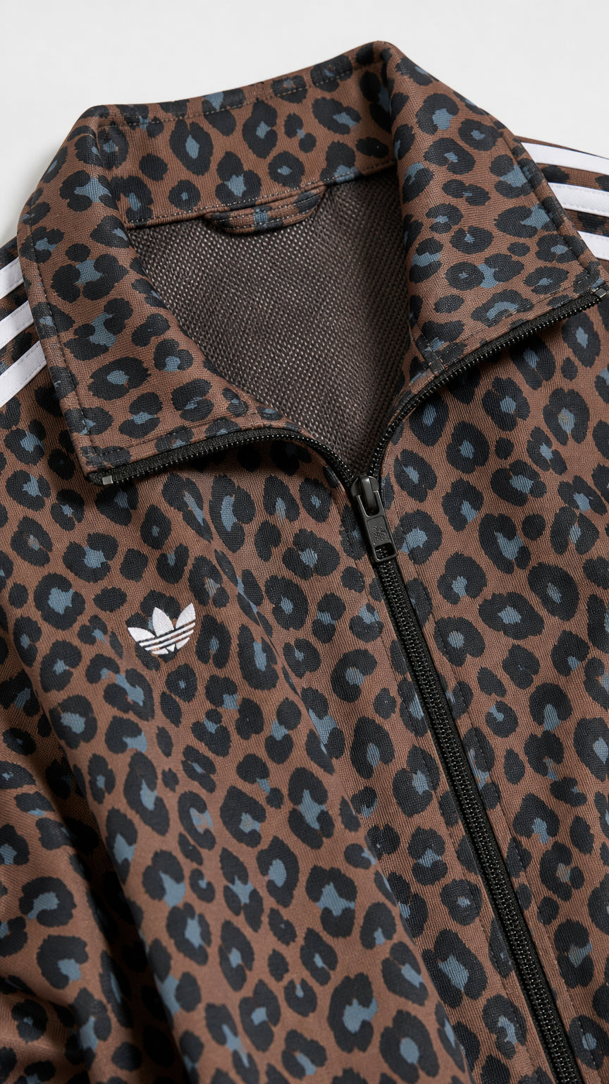 Close-up of brown leopard print fabric, collar, and zipper detail