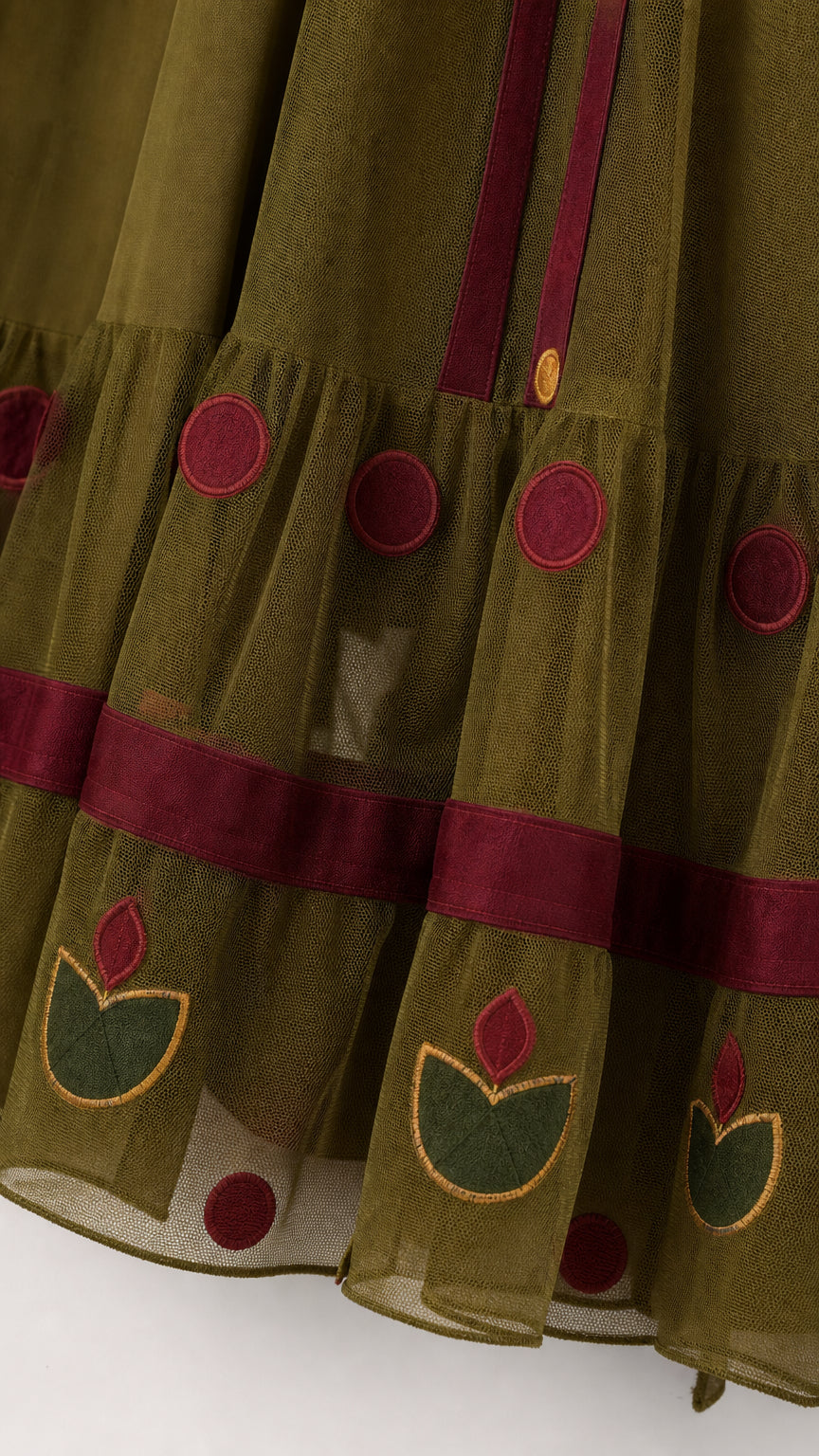 Close-up detail of floral embroidery and tiered mesh hem