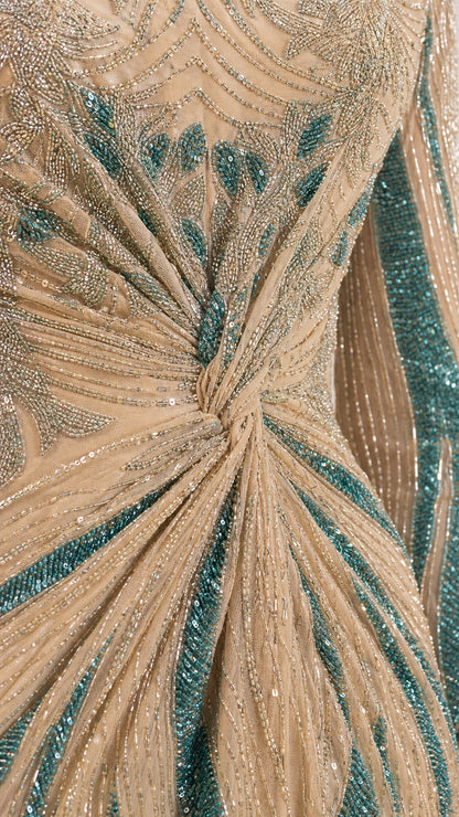 Close-up detail of knot front waistline with intricate teal beading and sequins