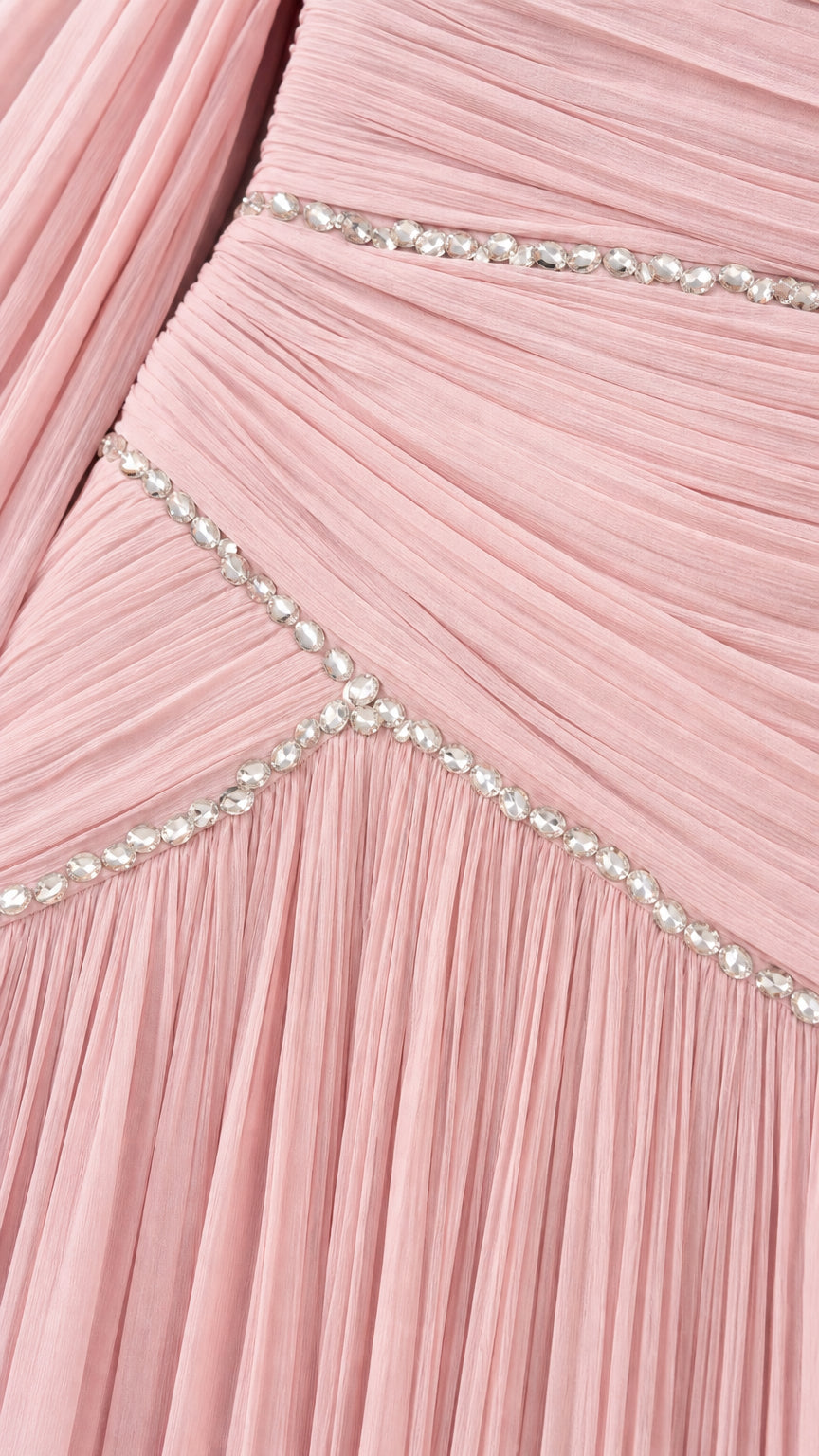 Close-up detail of blush pink pleated fabric with sparkling rhinestone trim lines