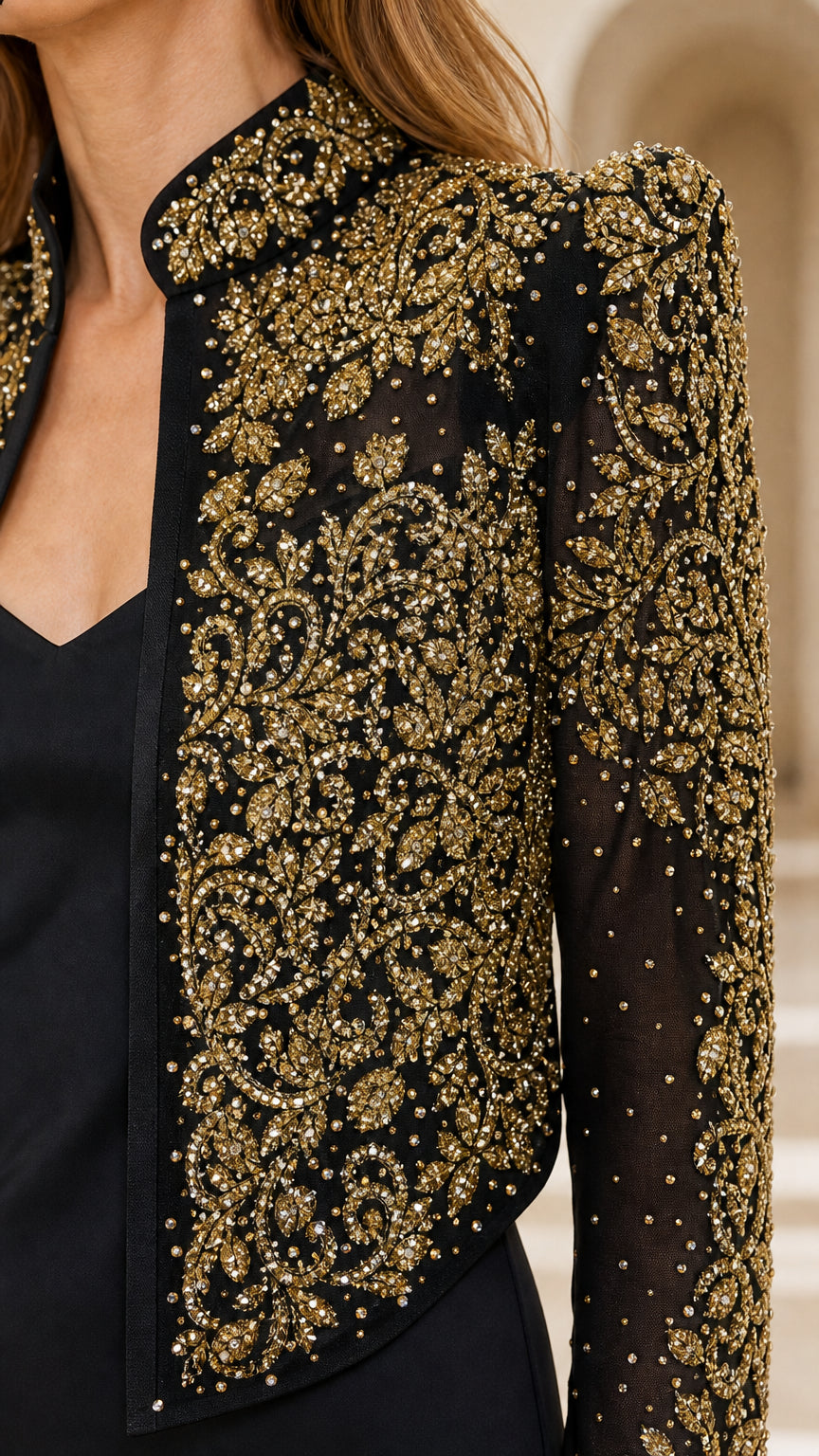 Close-up detail of gold embroidery and beadwork on black jacket