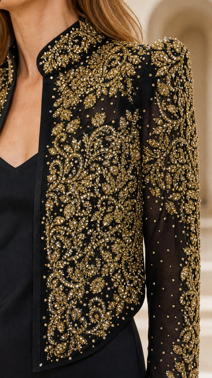 Close-up detail of gold embroidery and beadwork on black jacket