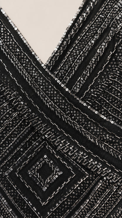Close-up detail of intricate diamond and linear sequin embroidery on V-neck bodice