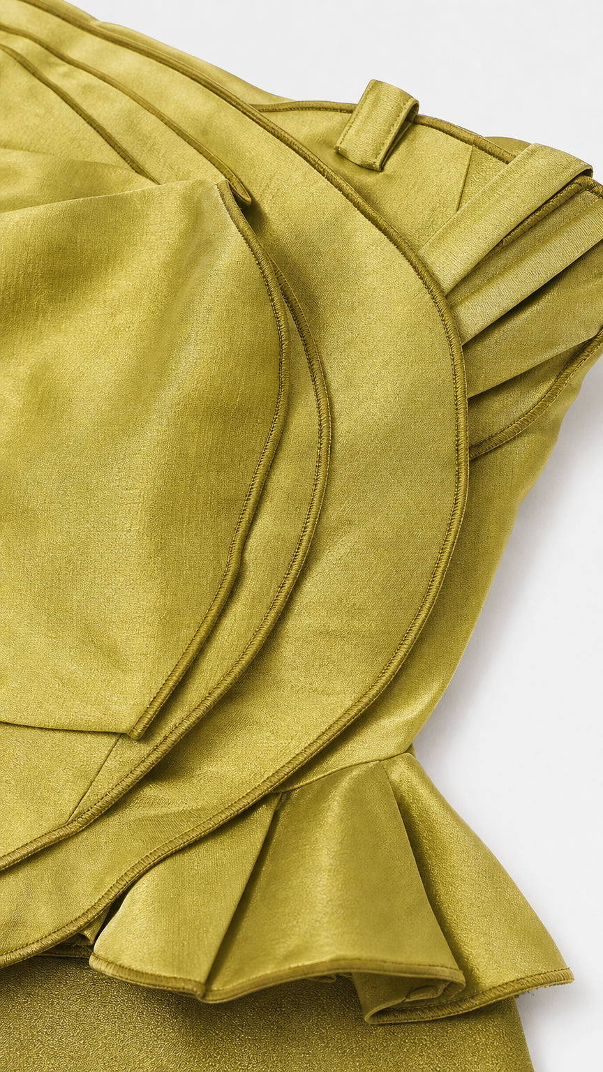 Close-up detail of structured ruffles on olive peplum top