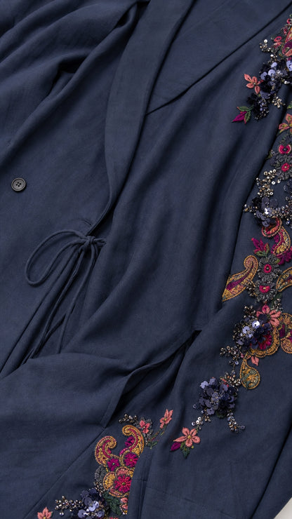 Close-up detail of navy fabric, drawstring waist, and floral embroidery