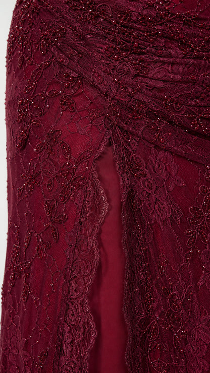 Close up of lace and bead detailing on the Burgundy evening dress skirt and slit