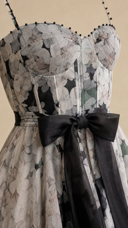 Close-up detail of sweetheart bodice, beaded straps, and satin bow