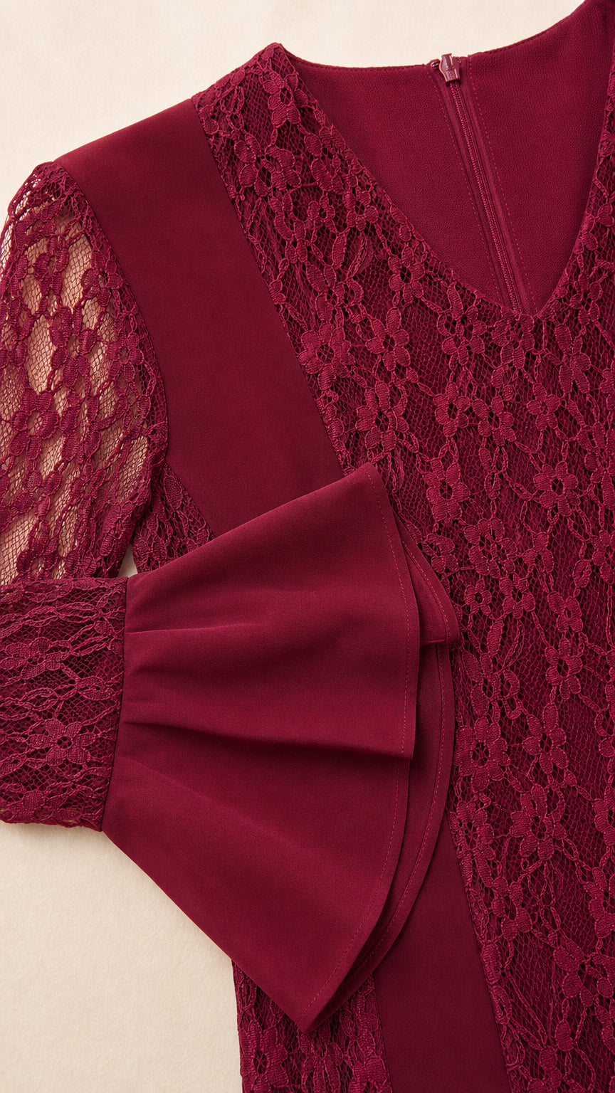 Close-up detail of burgundy floral lace, V-neckline, and fluted sleeve cuff