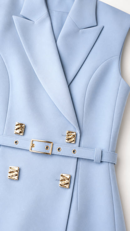 Close-up of light blue blazer lapel and gold buttons