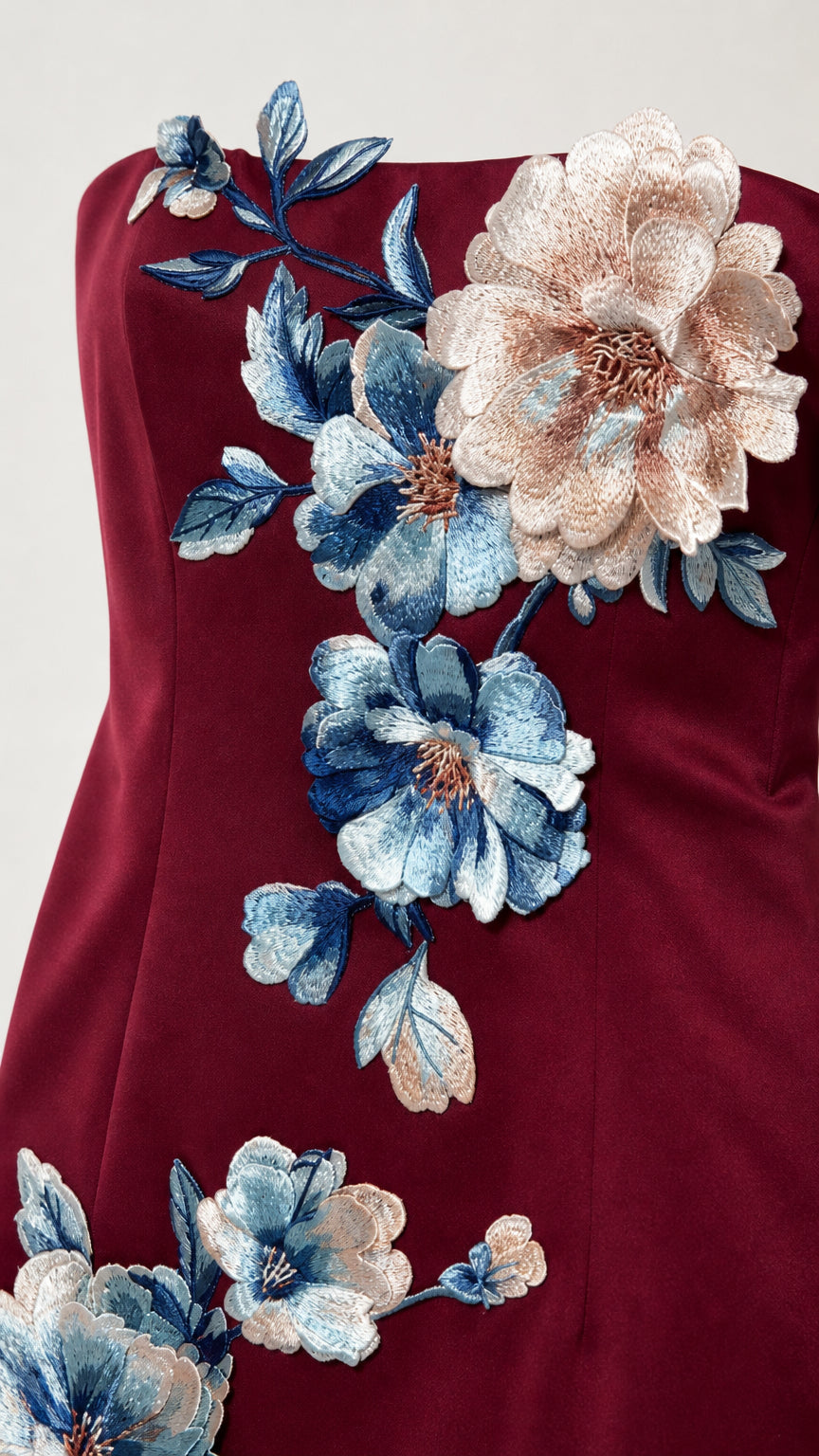 Close-up detail of 3d floral embroidery on burgundy dress