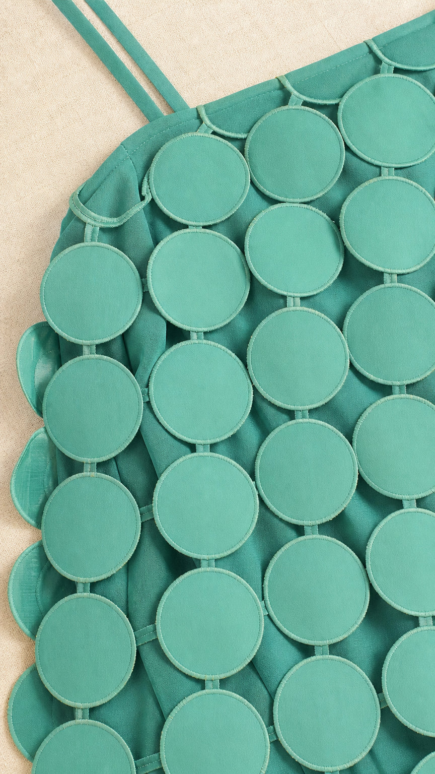 Close-up detail of sea green circular cutout overlay and strap