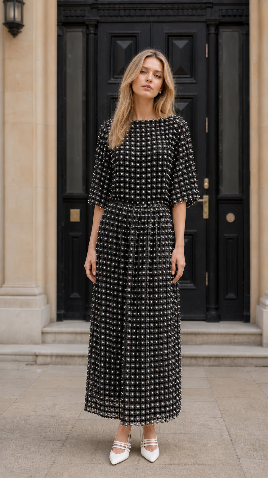 Front view of model wearing black textured pearl embellished midi dress