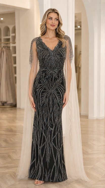 Front view of model wearing Black sequin embroidered V-neck evening gown with shoulder cape