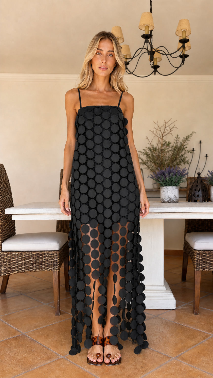 Front view of woman wearing black circle cutout maxi dress