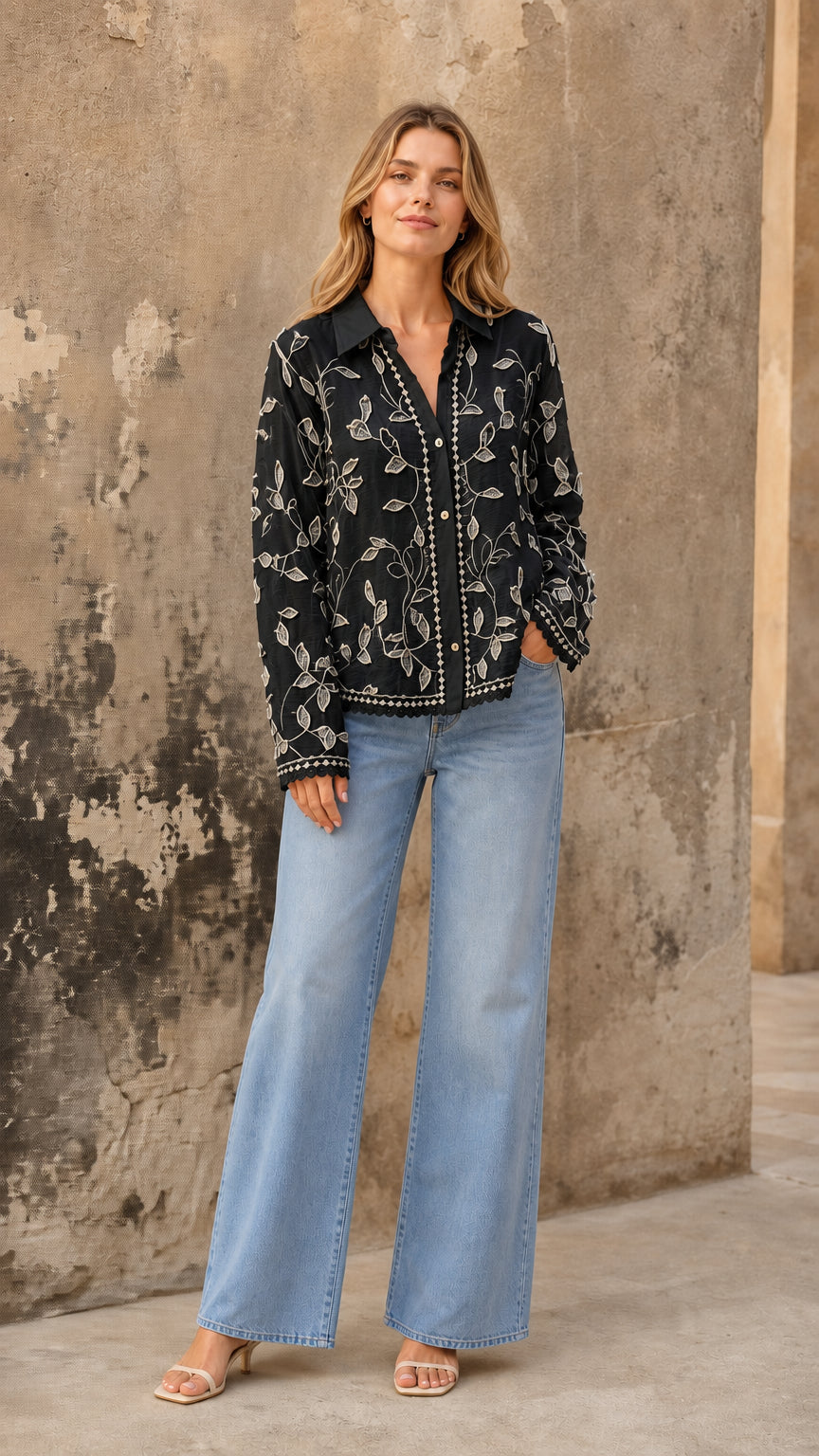 Black embroidered floral button-up blouse styled with light-wash jeans