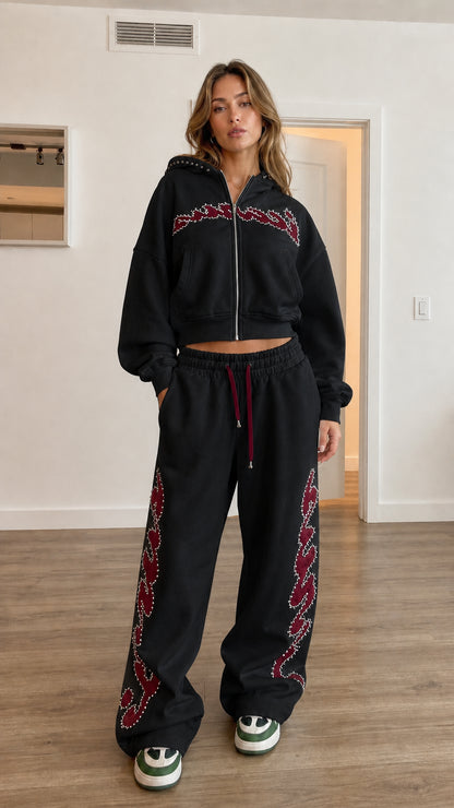 Model wearing black cropped hoodie and matching wide leg sweatpants set