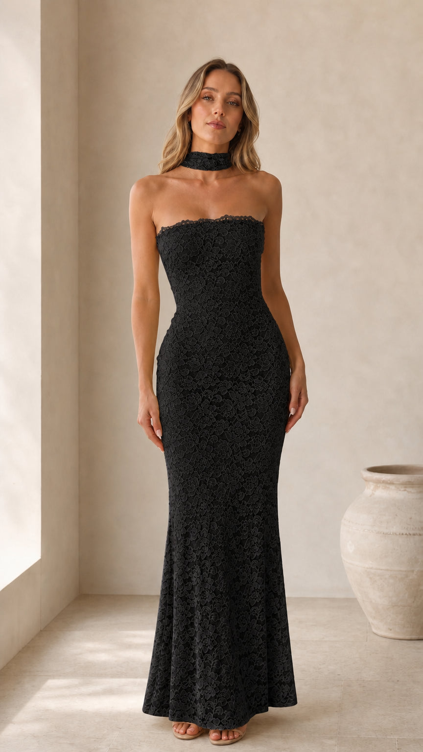 Front view of model wearing black strapless lace maxi dress