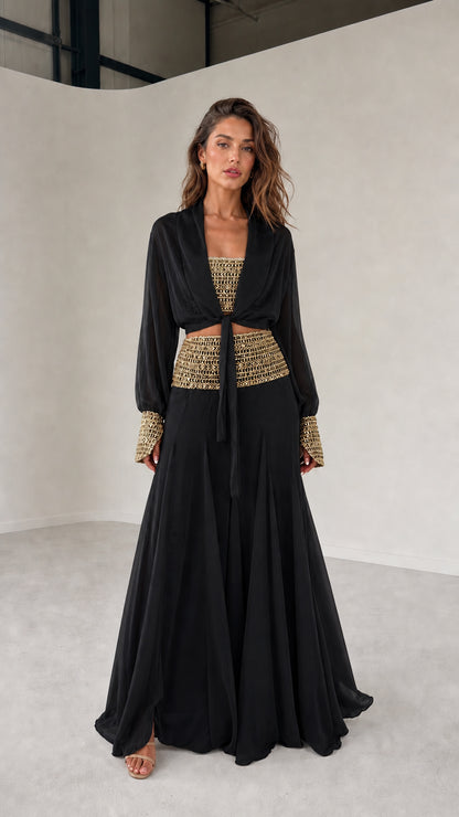 Model wearing black three-piece chiffon set