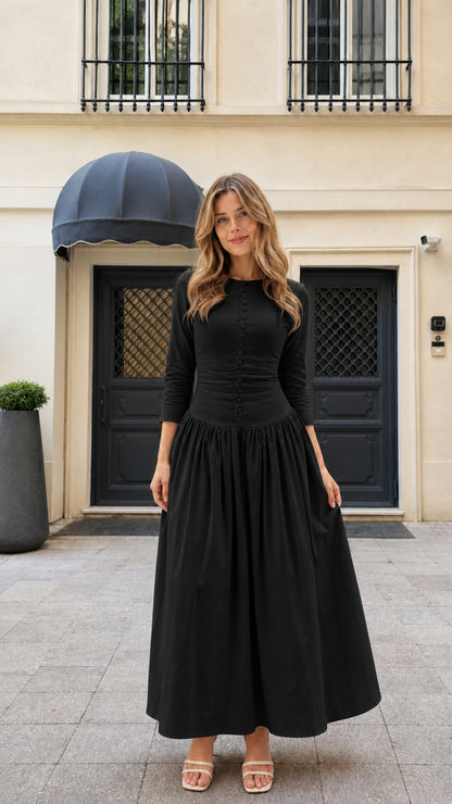 Model wearing black 3/4 sleeve pleated button-front maxi dress