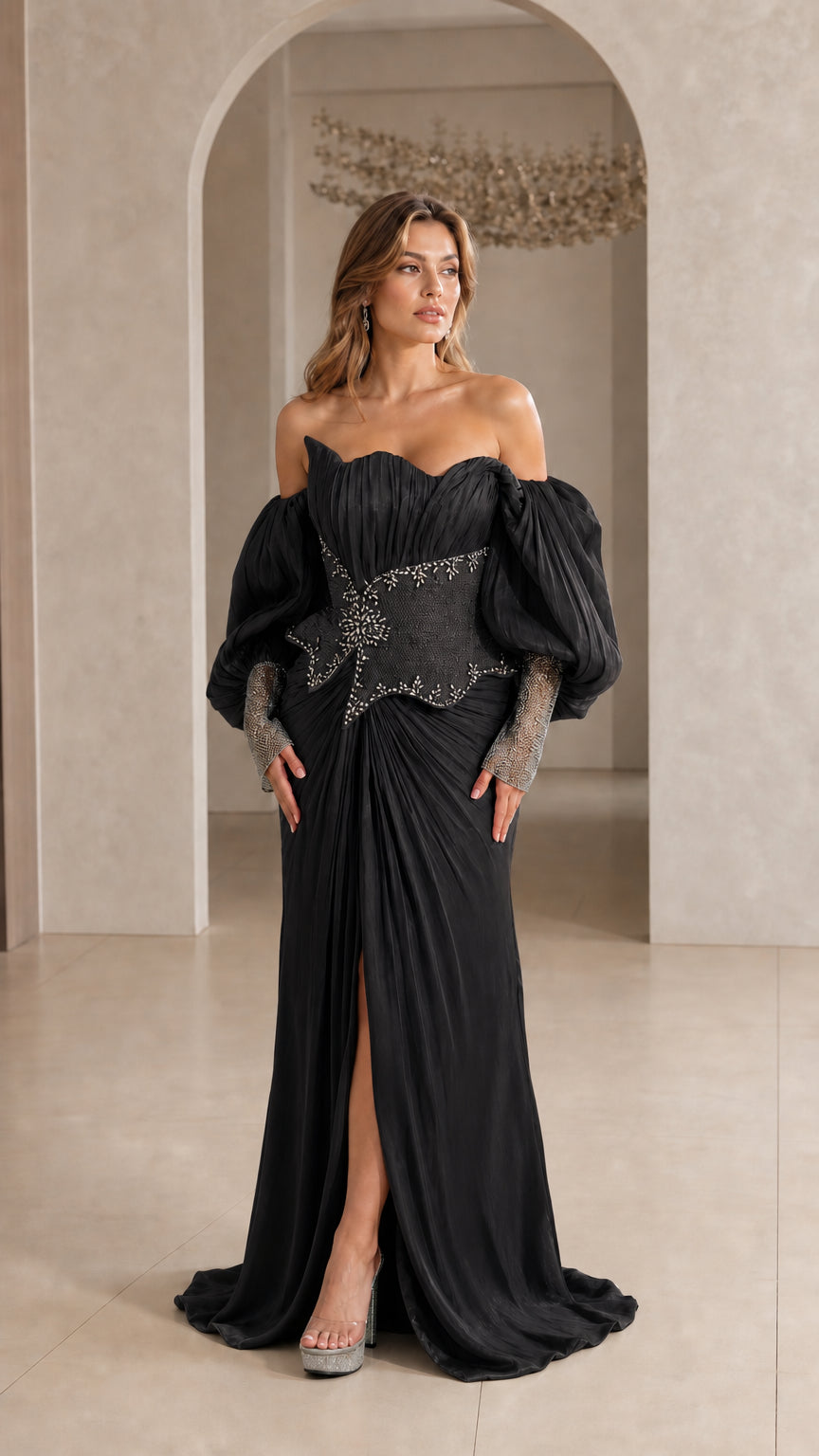 Model wearing Black off-the-shoulder pleated evening gown with beaded waist detail
