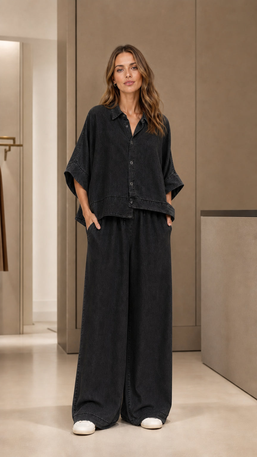 Full front view of model wearing black two-piece pants set