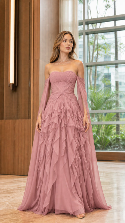 Model wearing dusty rose pink ruched formal gown with cascading ruffles