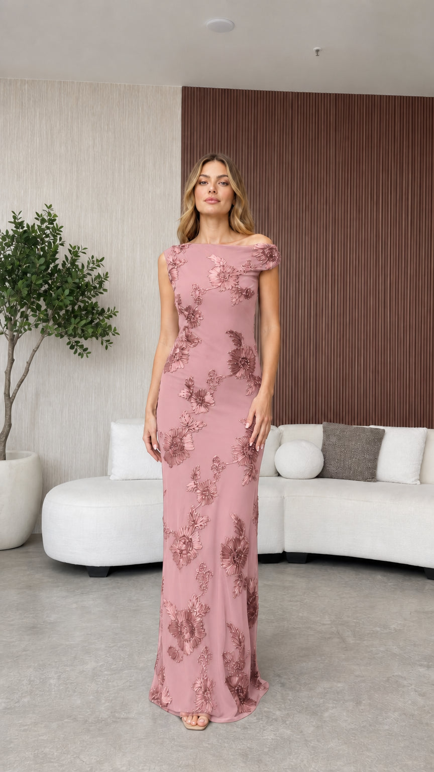 Model wearing pink evening dress with floral appliques