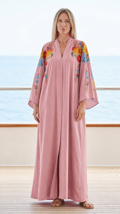 Model wearing pink floral embroidered maxi kaftan dress