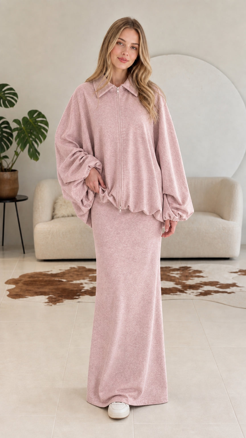 Model wearing dusty pink two-piece collared zip jacket and maxi skirt set