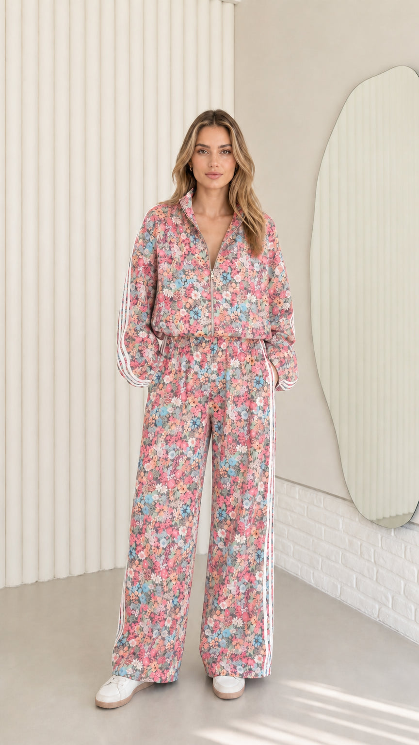 Woman wearing pink floral print zip-up tracksuit two-piece set