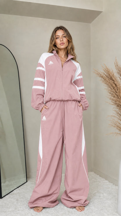 Front full-length view of woman wearing dusty pink colorblock tracksuit set
