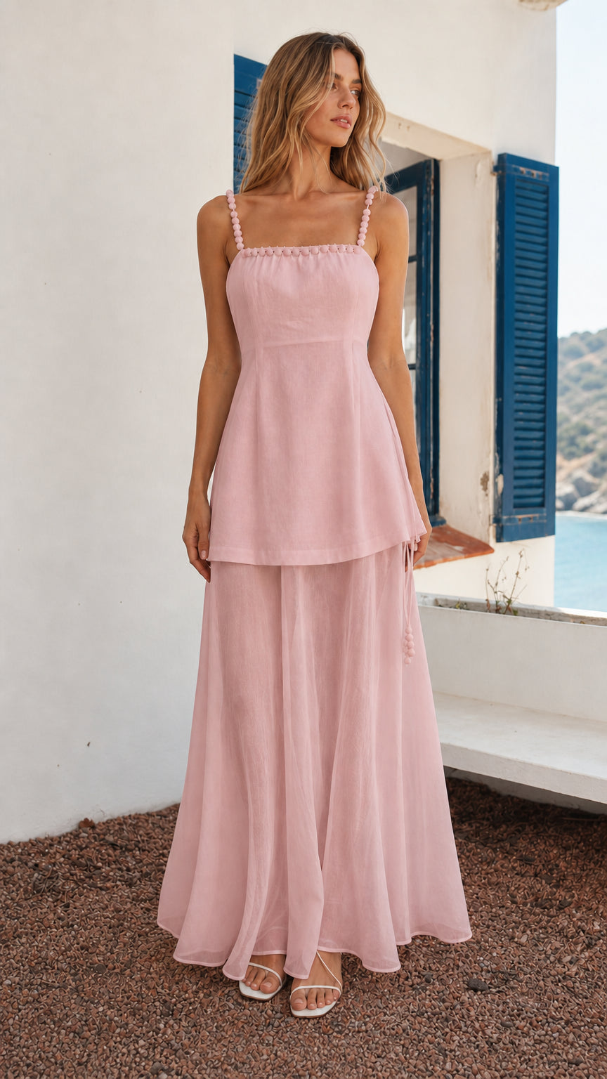 Front view of woman wearing pink beaded strap layered maxi dress