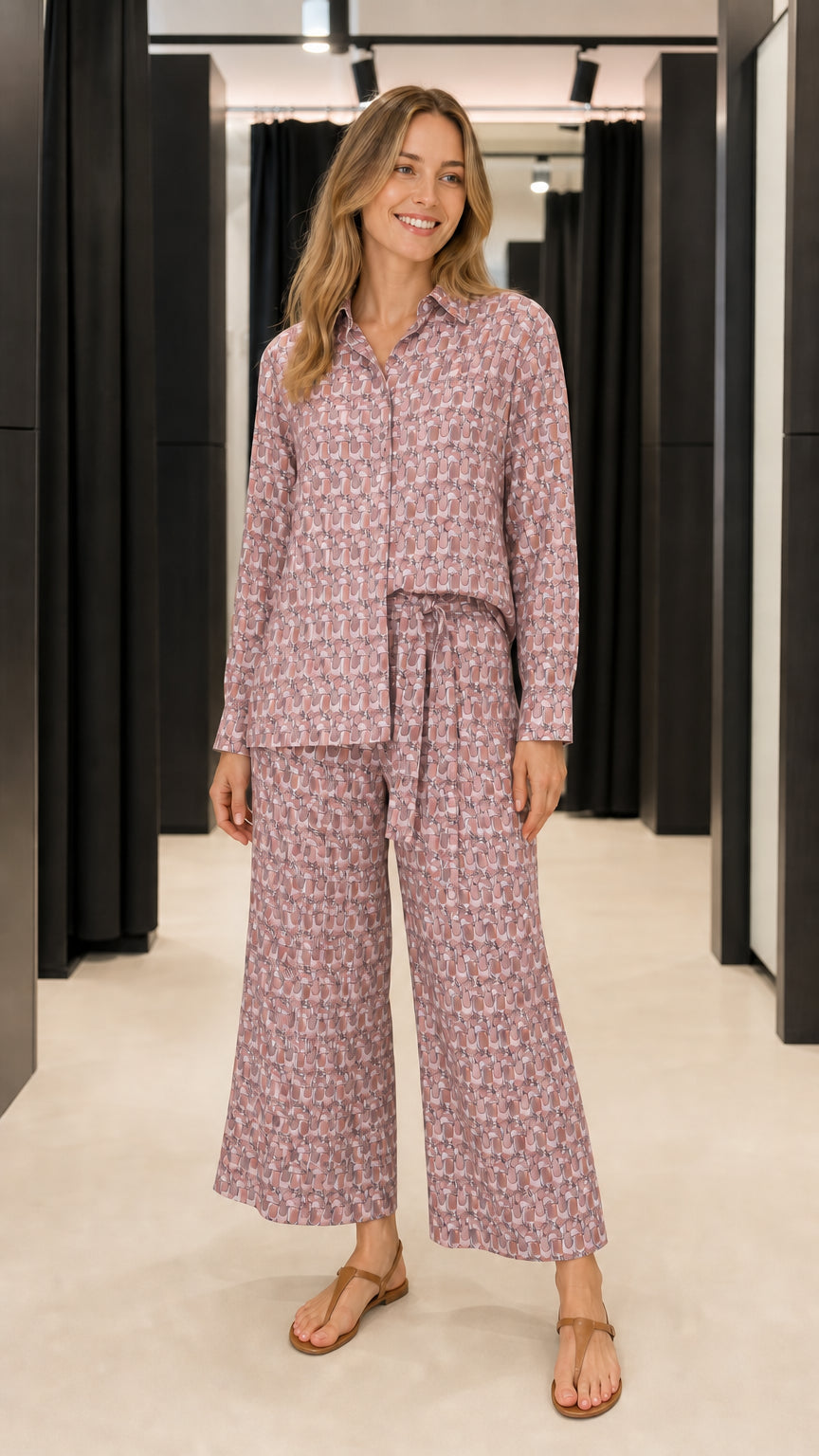 Woman wearing mauve geometric print matching shirt and trousers set